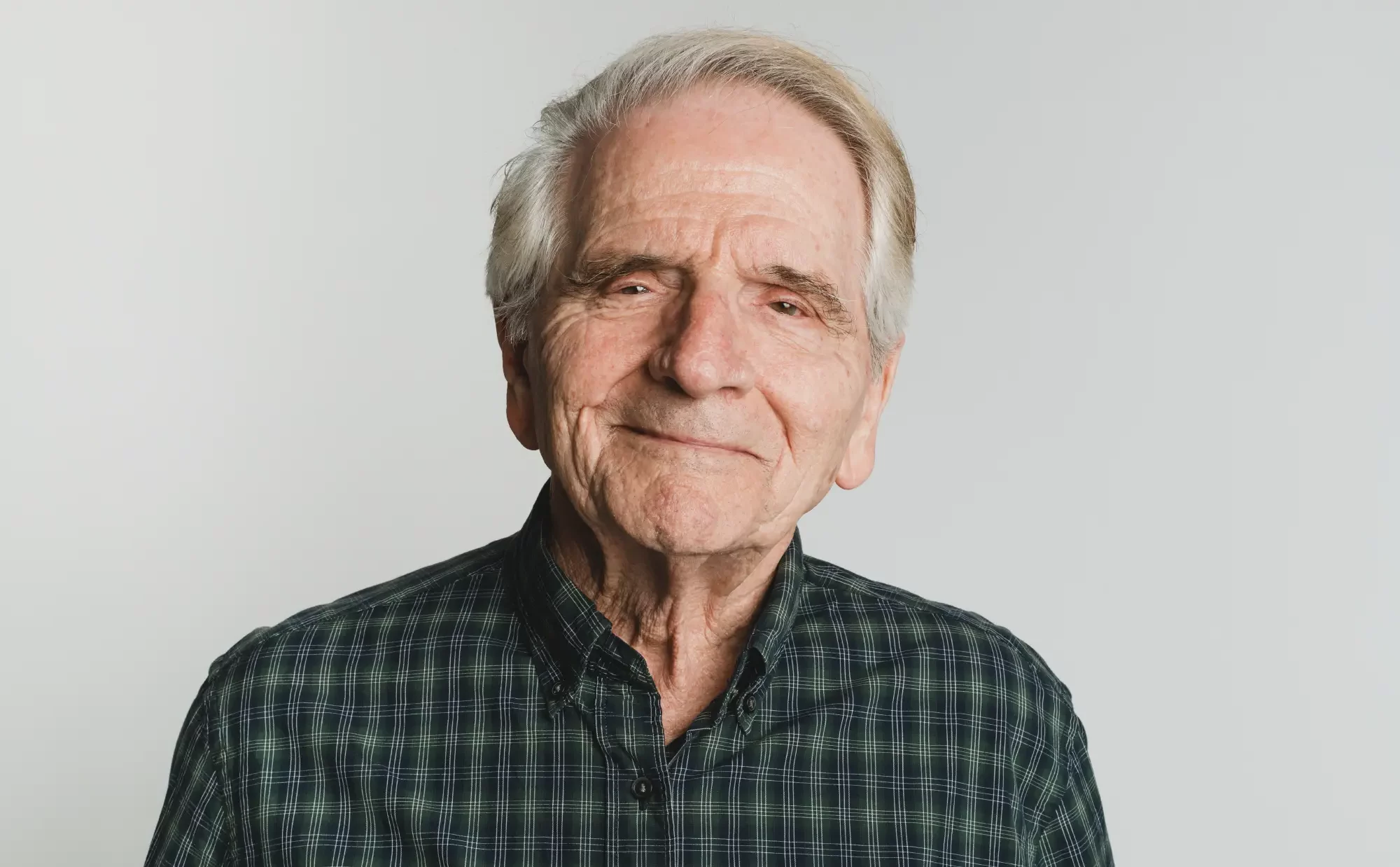 elderly caucasian man with white hair smiling
