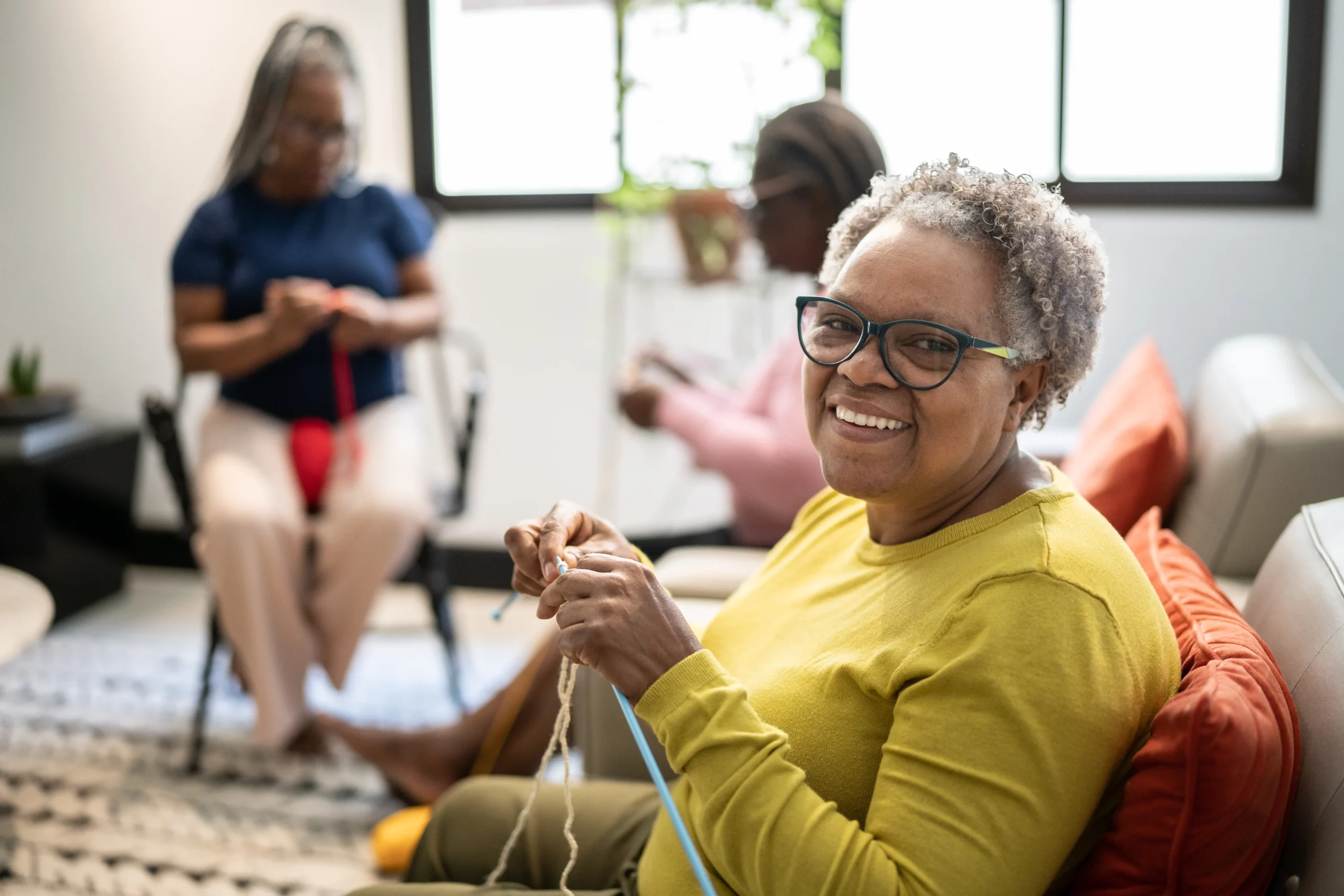 Senior woman knitting in a group
